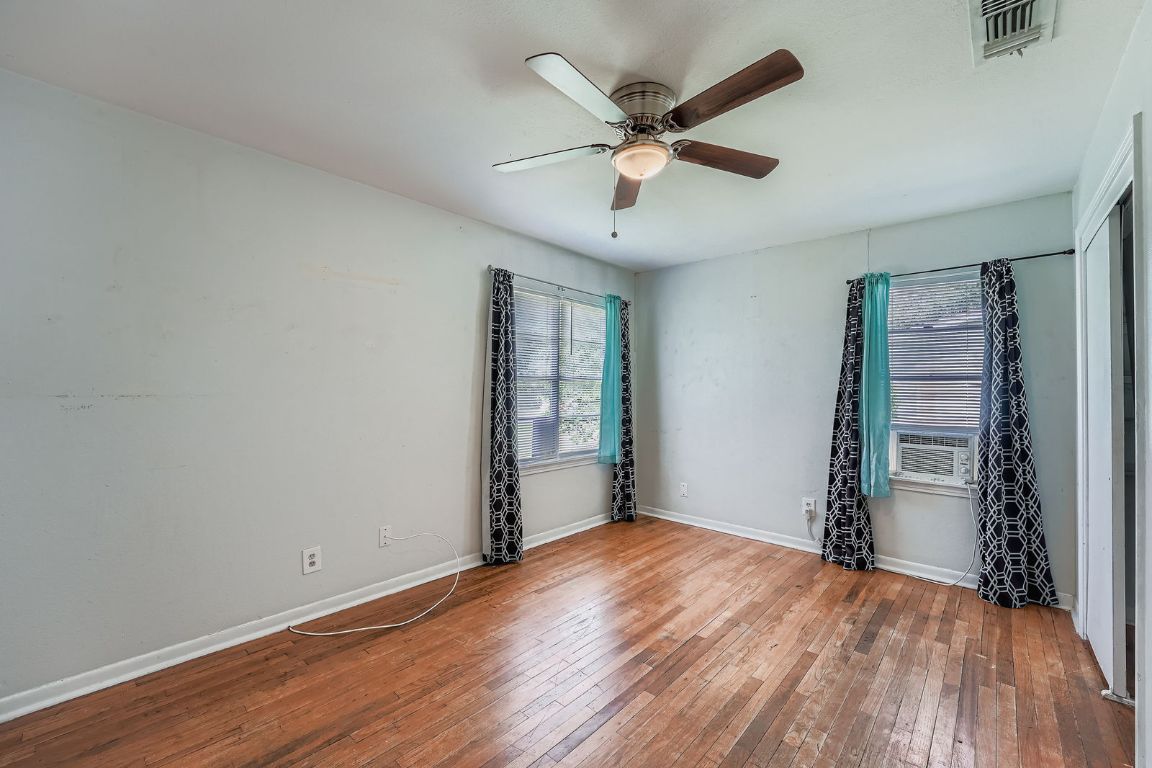 700 Blanco Street Kyle, TX 78640 - Photo 12 of 29 an empty room with wooden floor and windows