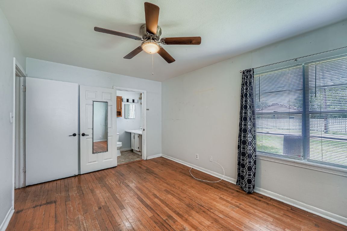 700 Blanco Street Kyle, TX 78640 - Photo 13 of 29 a view of empty room with wooden floor and fan