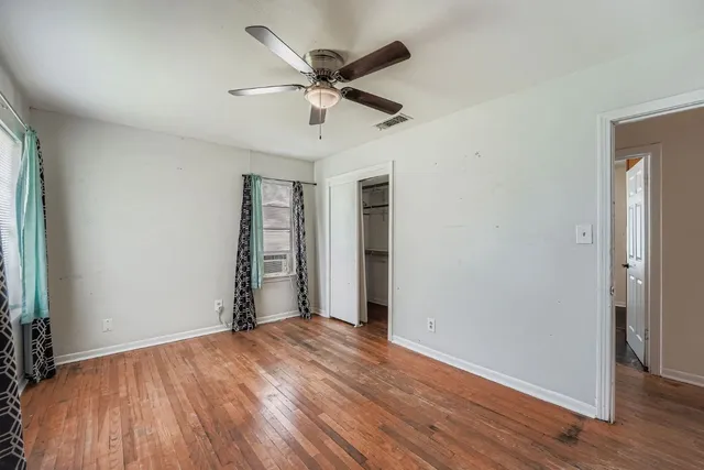 wooden floor in an empty room with a window