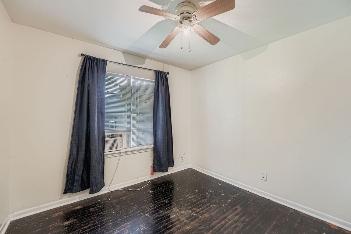 700 Blanco Street Kyle, TX 78640 - Photo 17 of 29 an empty room with wooden floor fan and windows