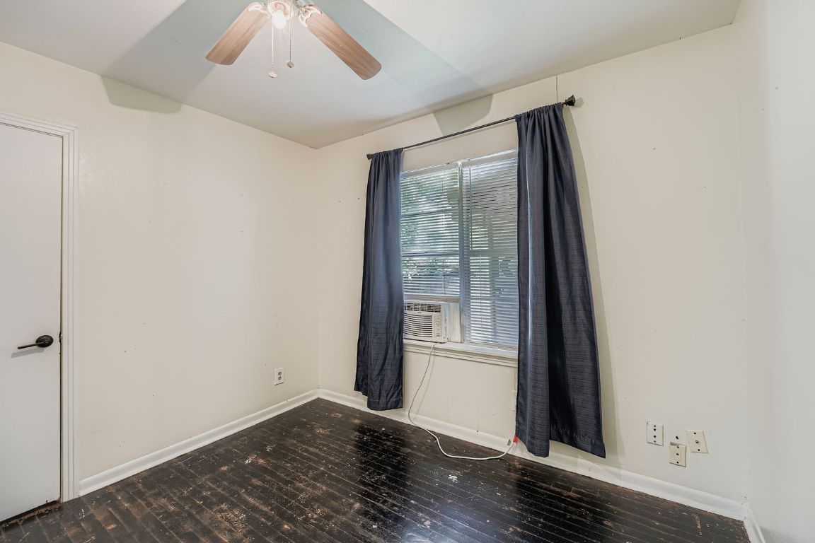 700 Blanco Street Kyle, TX 78640 - Photo 18 of 29 an empty room with wooden floor and windows