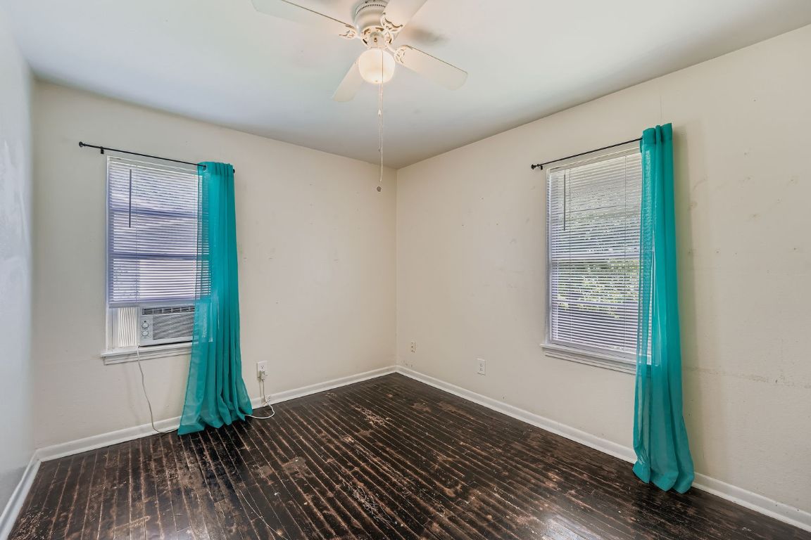 700 Blanco Street Kyle, TX 78640 - Photo 19 of 29 an empty room with wooden floor closet and windows