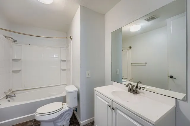 a bathroom with a sink toilet vanity and shower