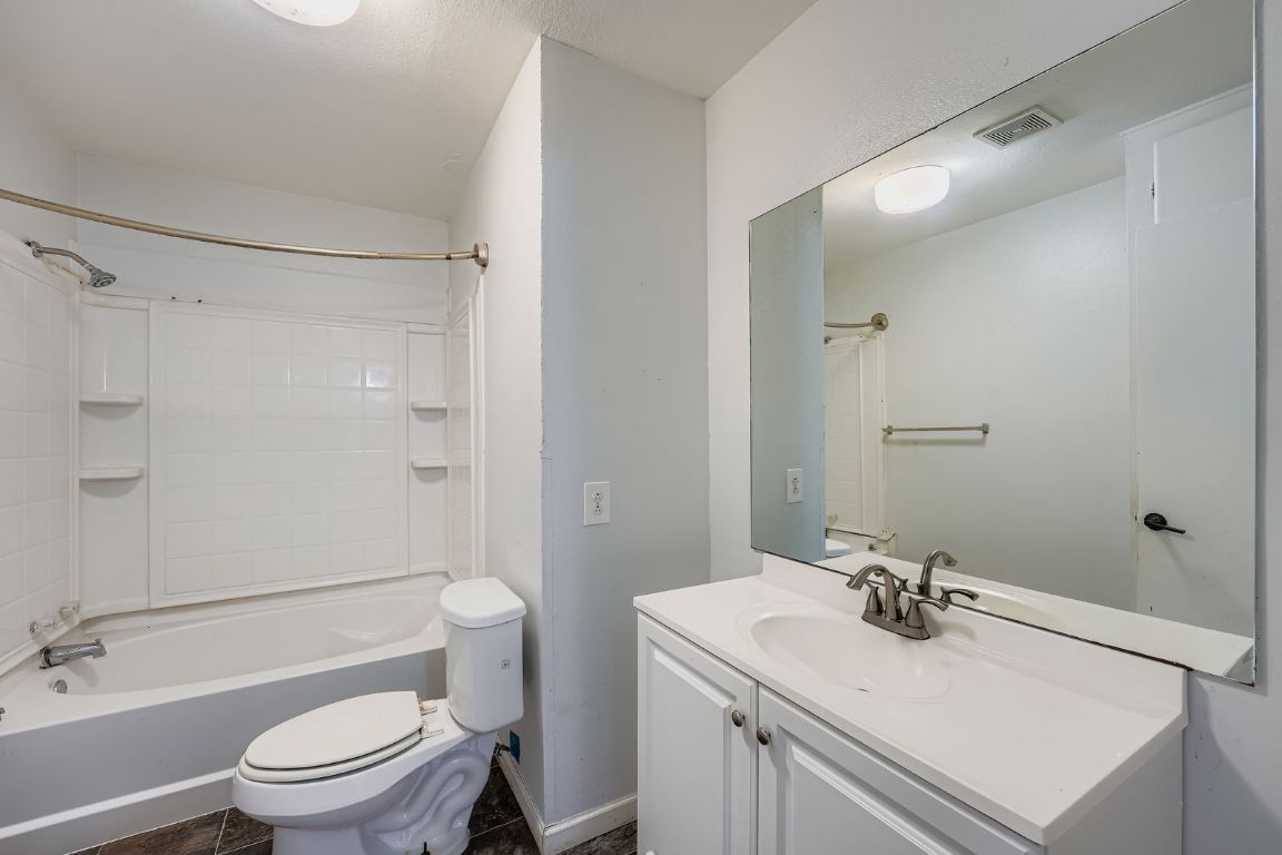 700 Blanco Street Kyle, TX 78640 - Photo 20 of 29 a bathroom with a sink toilet vanity and shower