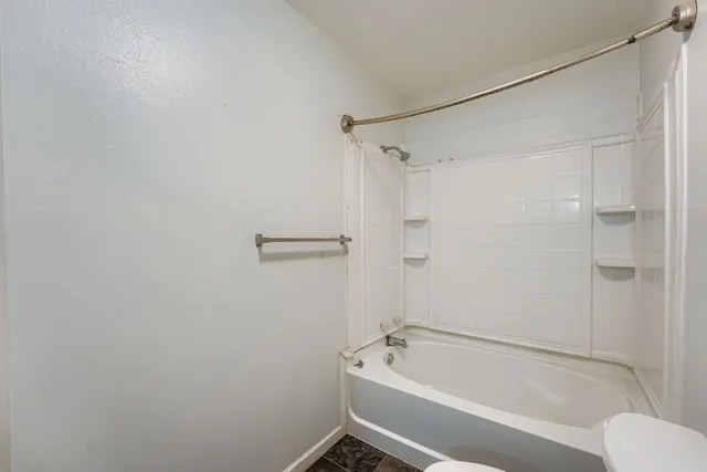 a bathroom with a tub and shower