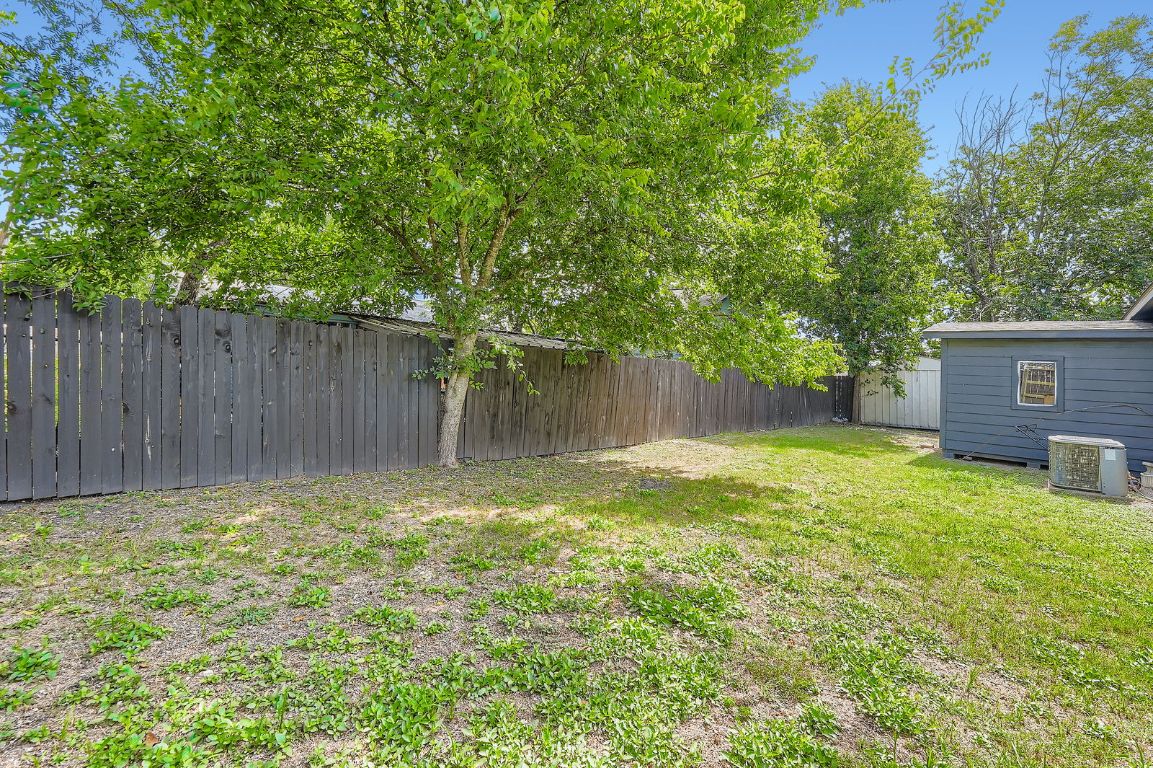 700 Blanco Street Kyle, TX 78640 - Photo 25 of 29 a view of a backyard with a small cabin