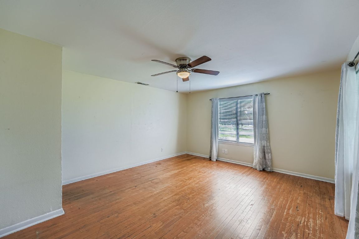 700 Blanco Street Kyle, TX 78640 - Photo 7 of 29 an empty room with wooden floor and windows