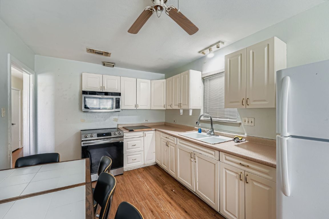 700 Blanco Street Kyle, TX 78640 - Photo 9 of 29 a kitchen with a sink appliances and cabinets