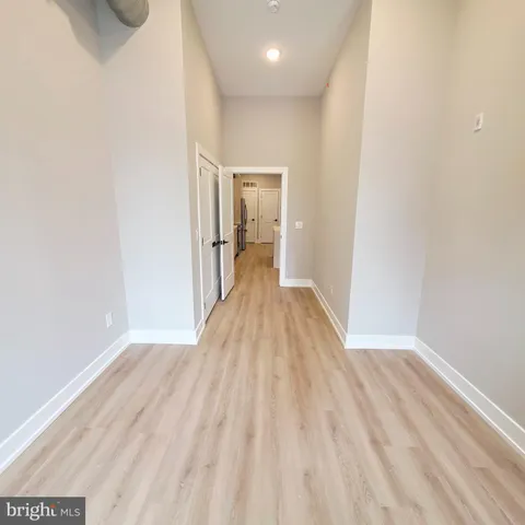 a view of a room with wooden floor