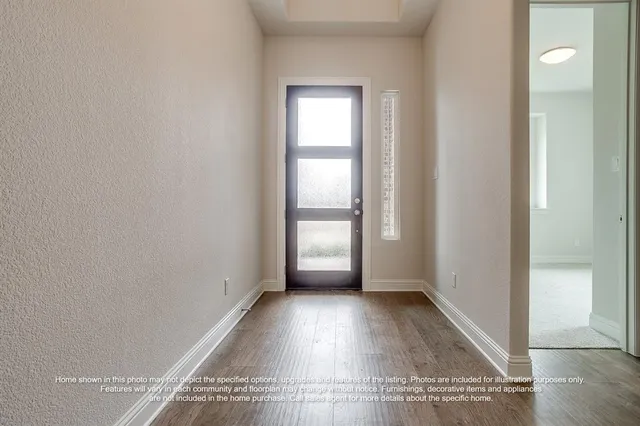 an empty room with wooden floor and a window