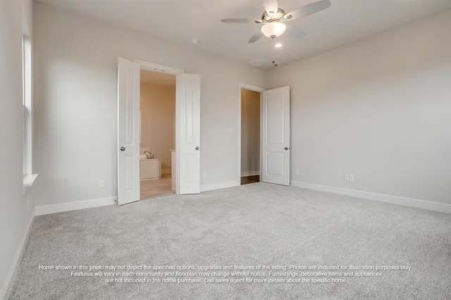 an empty room with fan and entryway