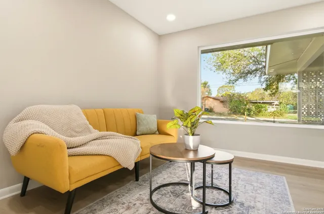 a living room with furniture and a large window