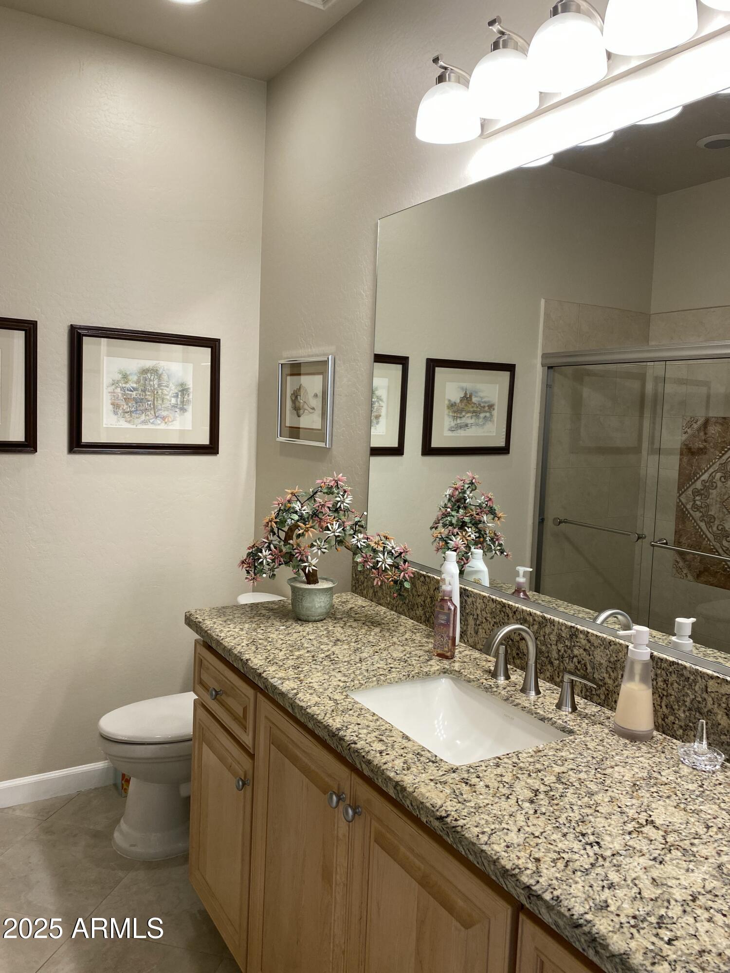 4777 South Fulton Ranch Boulevard, Unit 1074 Chandler, AZ 85248 - Photo 14 of 28 a bathroom with a granite countertop sink and a mirror