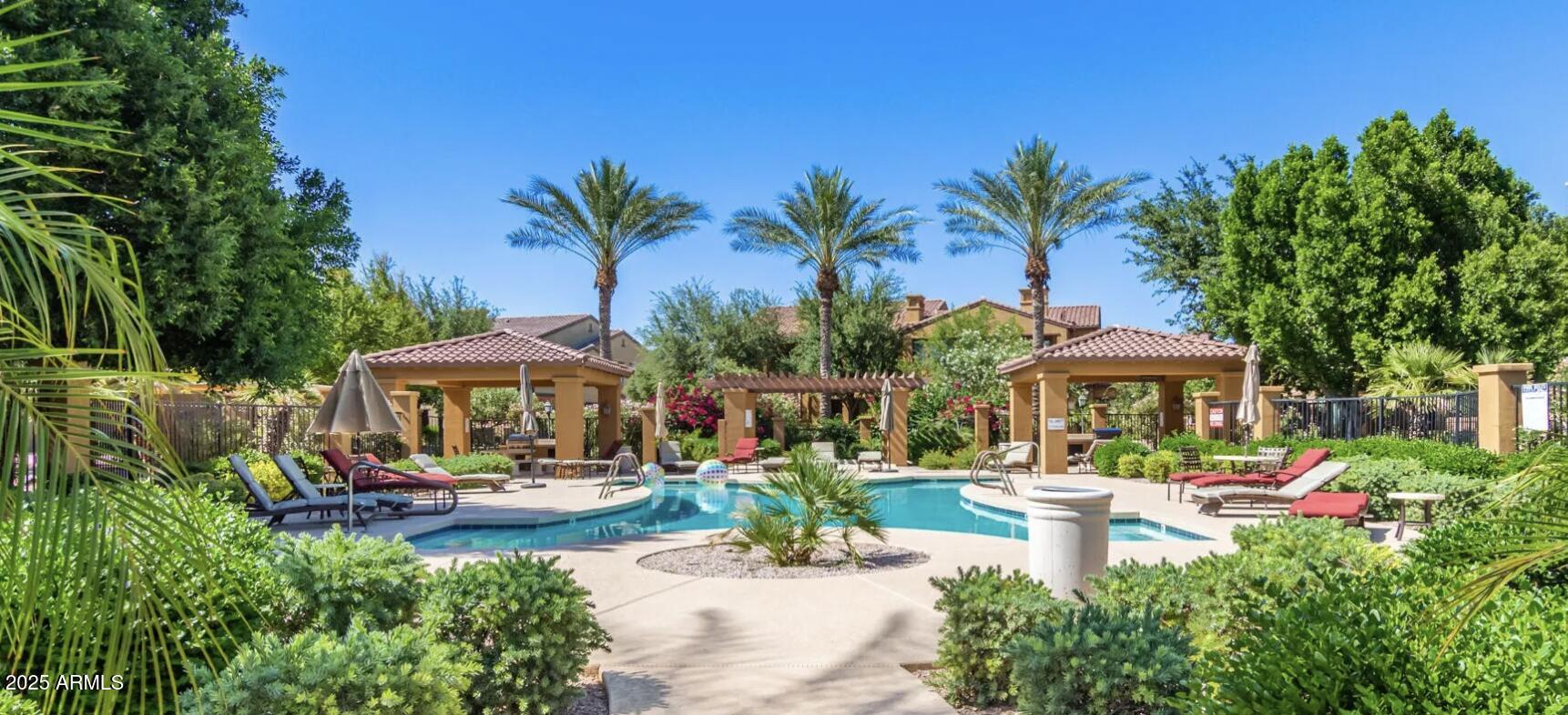 4777 South Fulton Ranch Boulevard, Unit 1074 Chandler, AZ 85248 - Photo 24 of 28 a view of a swimming pool with chairs and a patio
