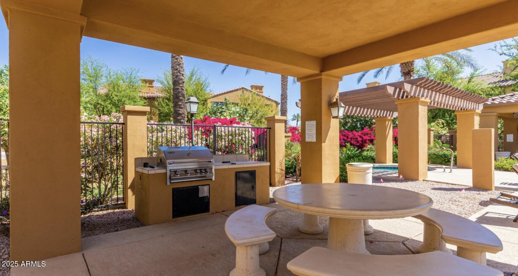 4777 South Fulton Ranch Boulevard, Unit 1074 Chandler, AZ 85248 - Photo 26 of 28 a kitchen with a stove a sink and a dining table