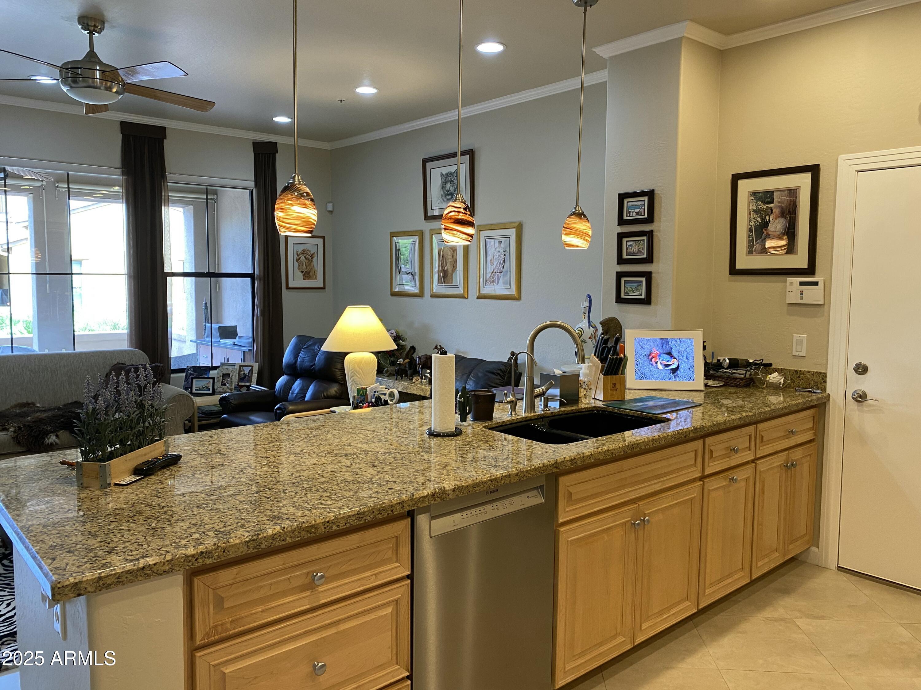 4777 South Fulton Ranch Boulevard, Unit 1074 Chandler, AZ 85248 - Photo 2 of 28 a kitchen with kitchen island granite countertop a sink cabinets and window