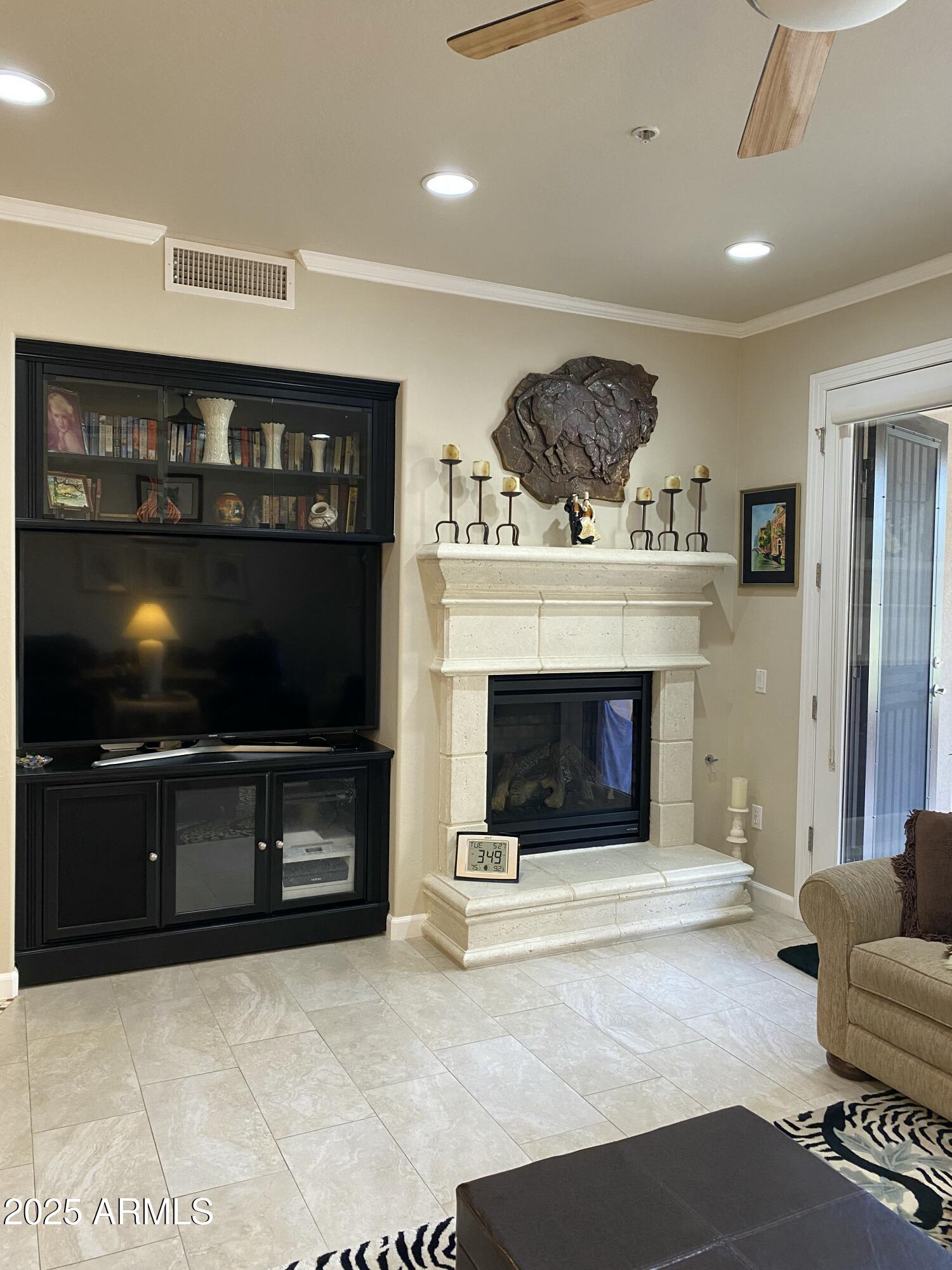 4777 South Fulton Ranch Boulevard, Unit 1074 Chandler, AZ 85248 - Photo 6 of 28 a living room with furniture a flat screen tv and a fireplace