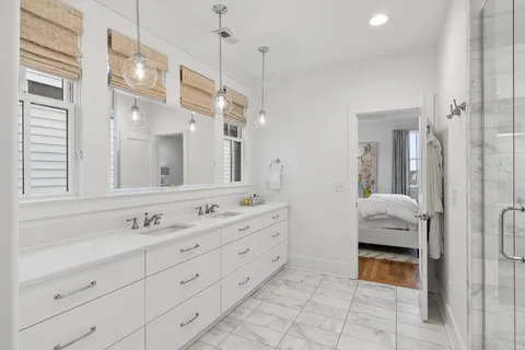 a en suite bathroom with a double sink and mirror