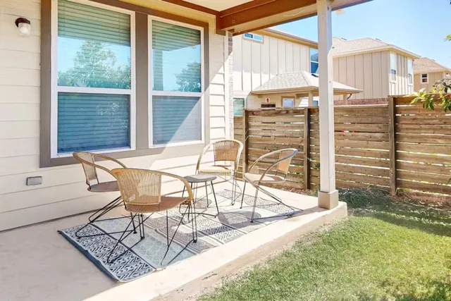 a view of a chairs and table in the balcony