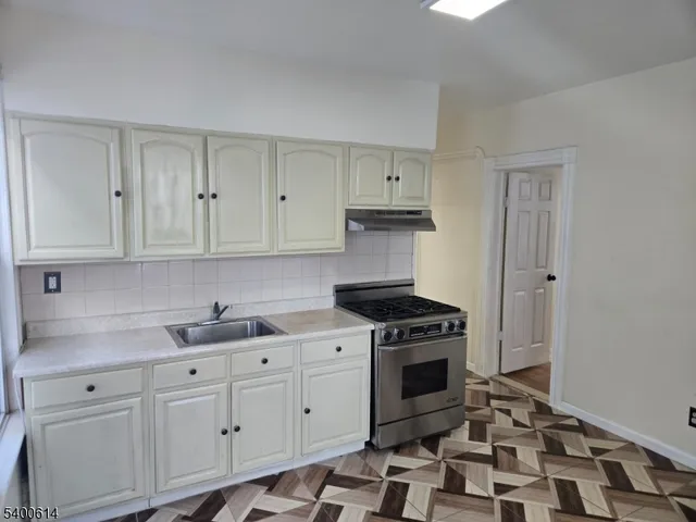 a kitchen with cabinets appliances and a sink