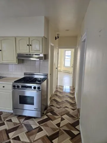 a kitchen with a stove and a refrigerator