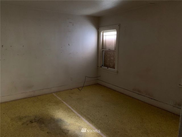 an empty room with a empty space and a window