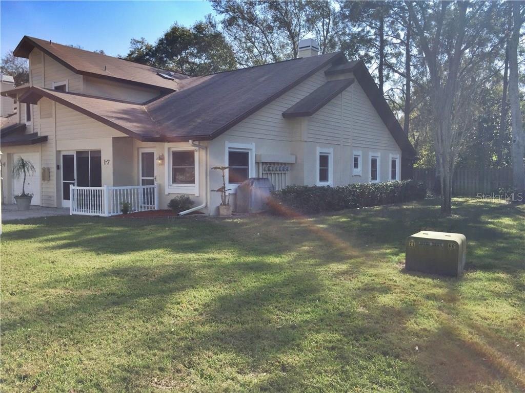 609 Green Valley Road, Unit I7 Palm Harbor, FL 34683 - Photo 1 of 1 a backyard of a house with yard and outdoor seating