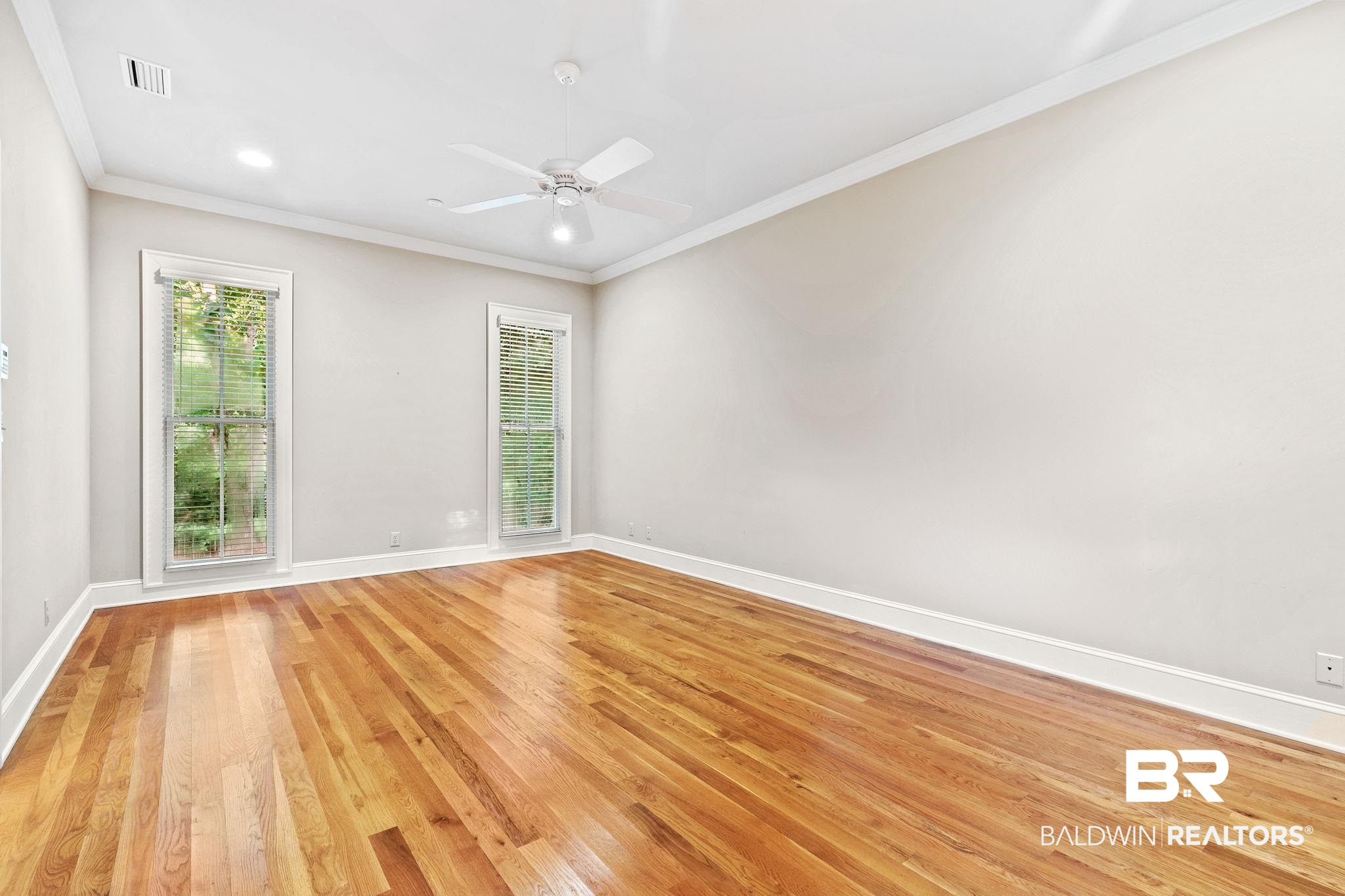 202 Beall Lane Daphne, AL 36526 - Photo 19 of 46 Unfurnished room with a healthy amount of sunlight, light hardwood / wood-style flooring, and ceiling fan
