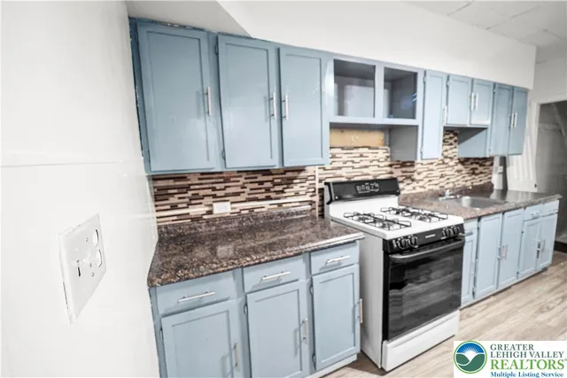 a kitchen with granite countertop a sink and a wooden cabinets
