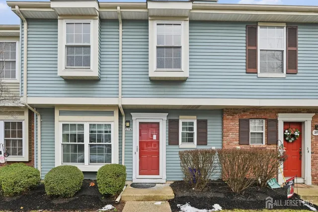 a kitchen with granite countertop a stove top oven cabinets and a refrigerator