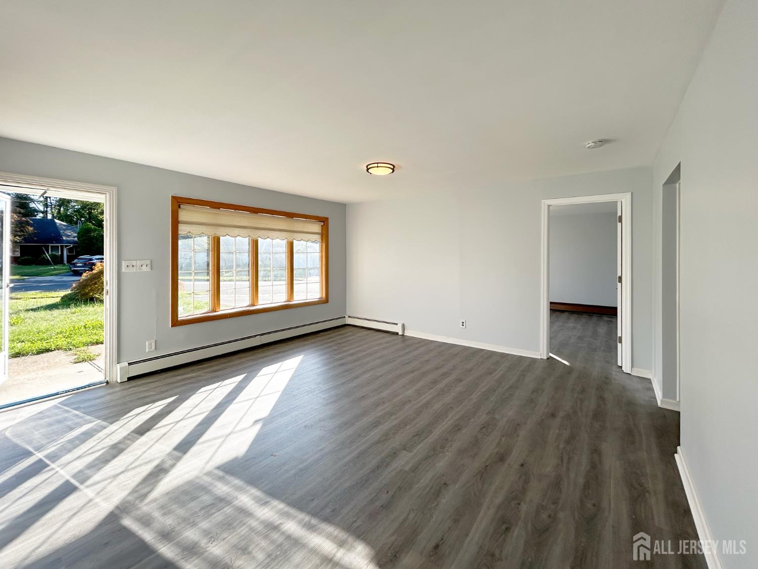 3 Stiles Road Edison, NJ 08817 - Photo 5 of 21 an empty room with wooden floor and windows