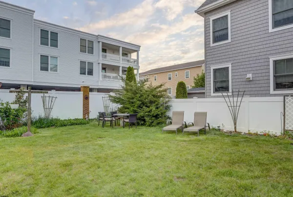 a view of a house with a yard and sitting area