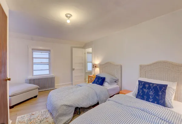 a bedroom with two beds and a couch