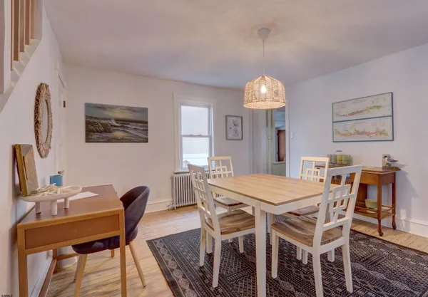a view of a dining room with furniture and chandelier