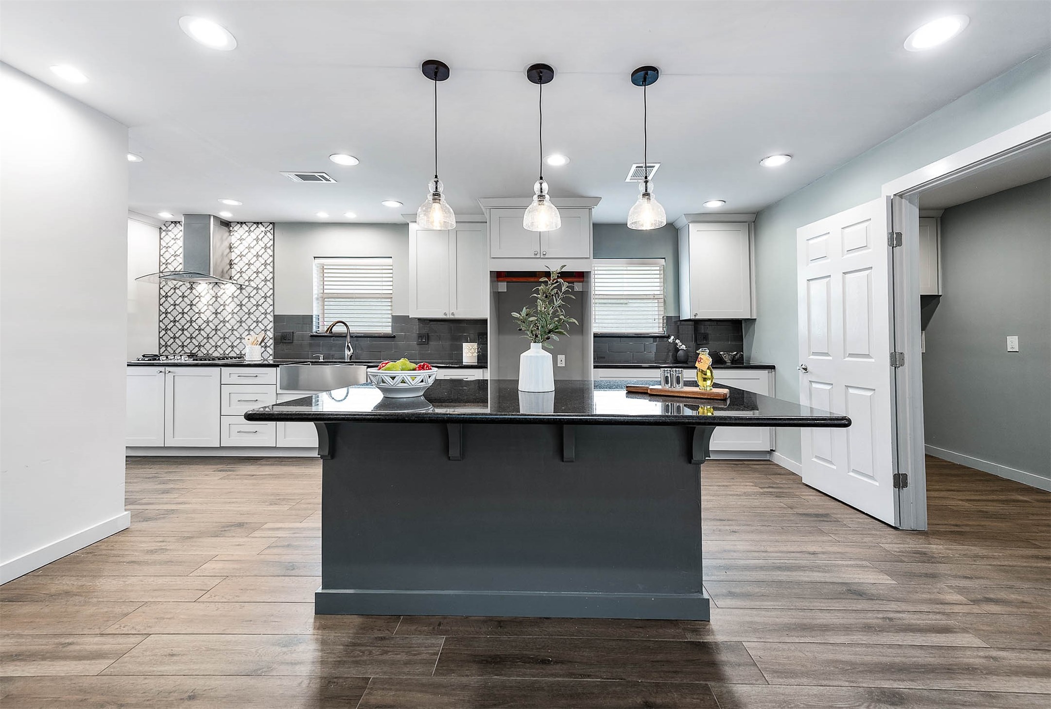 6030 Warm Springs Road Houston, TX 77035 - Photo 14 of 40 a kitchen with granite countertop a sink cabinets and wooden floor