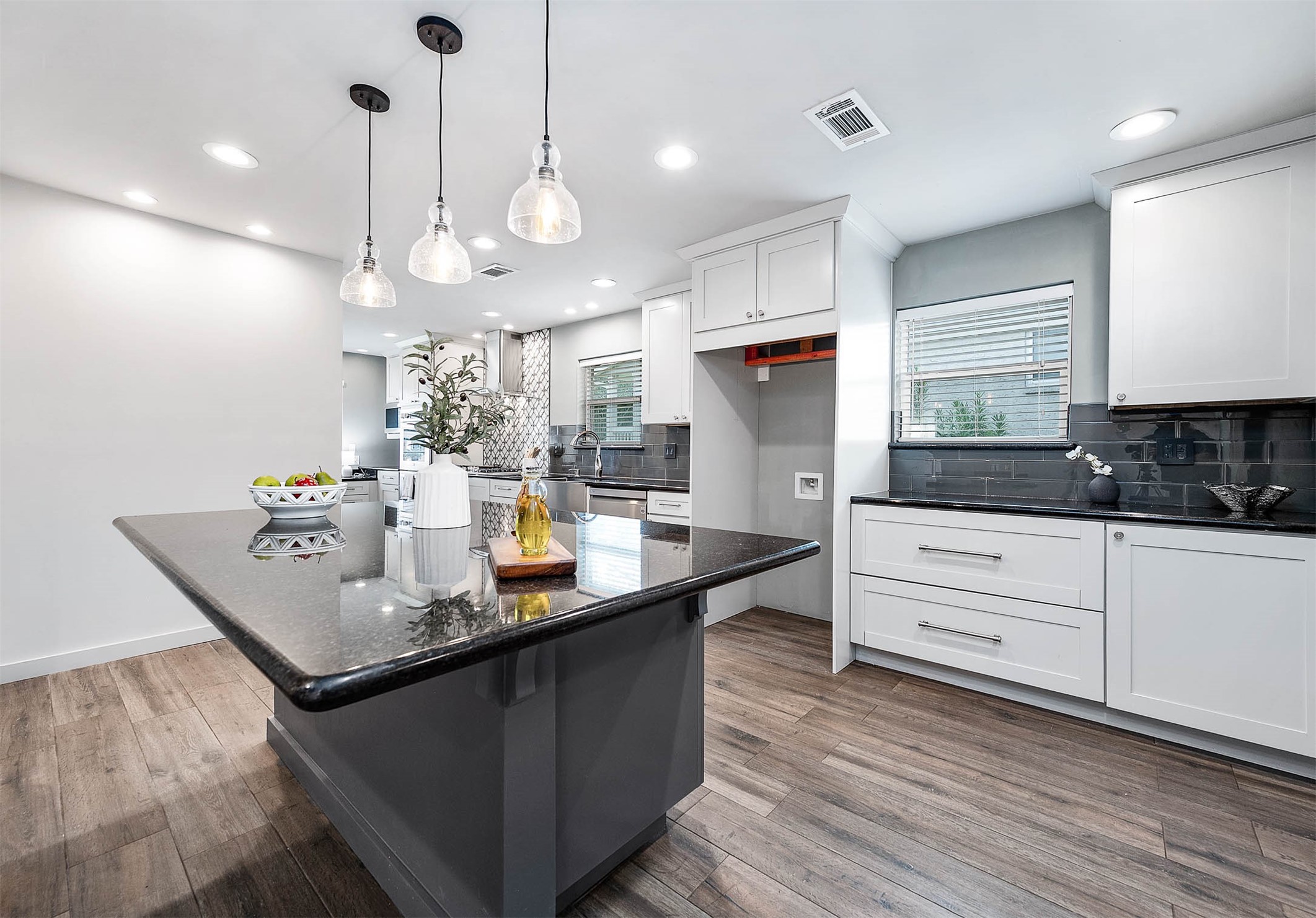 6030 Warm Springs Road Houston, TX 77035 - Photo 15 of 40 a kitchen with stainless steel appliances granite countertop a sink a stove and a wooden floor