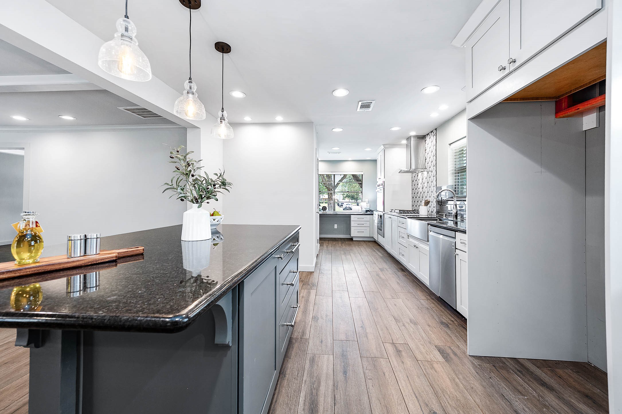6030 Warm Springs Road Houston, TX 77035 - Photo 16 of 40 a kitchen with counter space and wooden floor