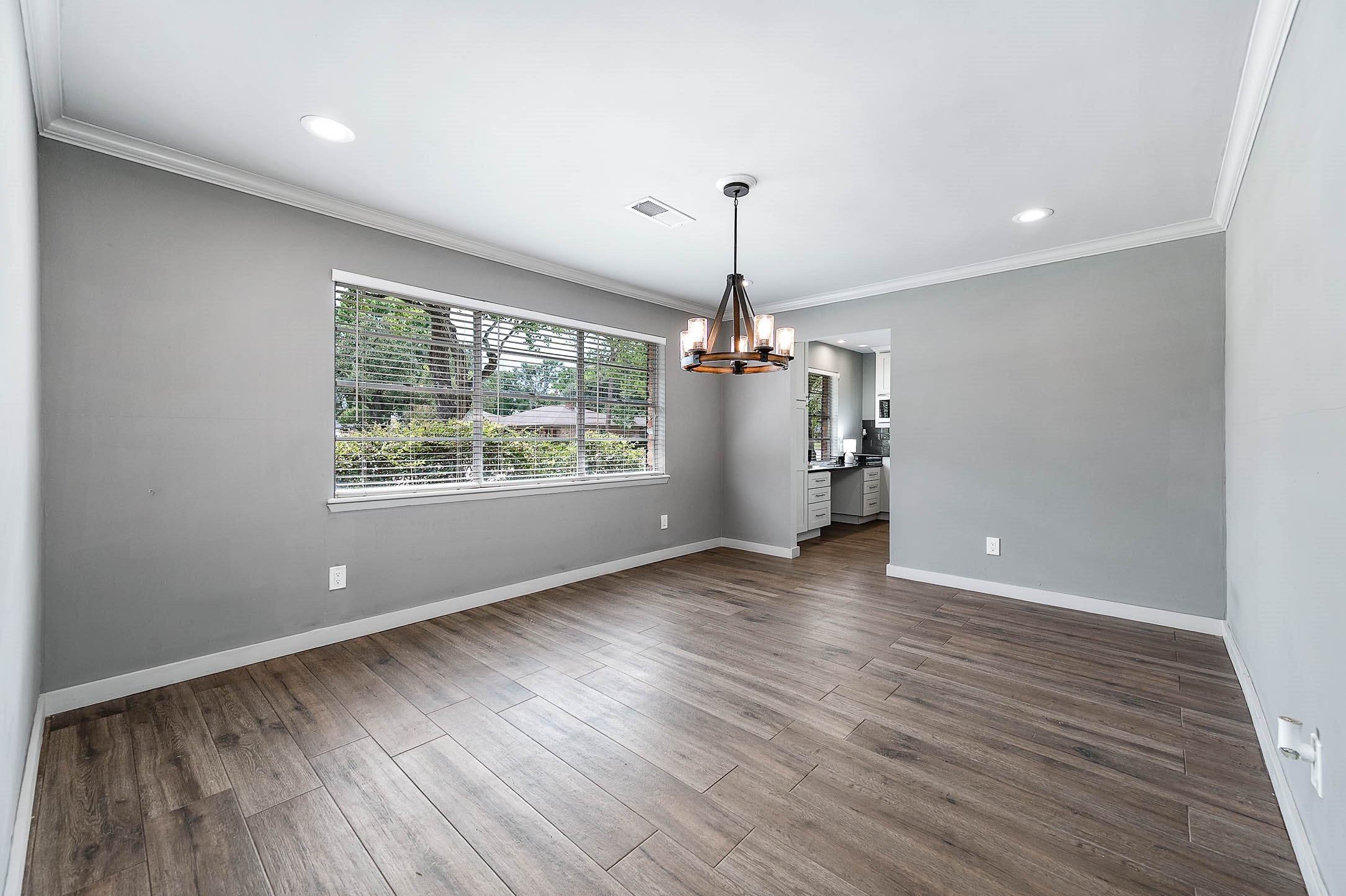 6030 Warm Springs Road Houston, TX 77035 - Photo 9 of 40 a view of empty room with wooden floor and window