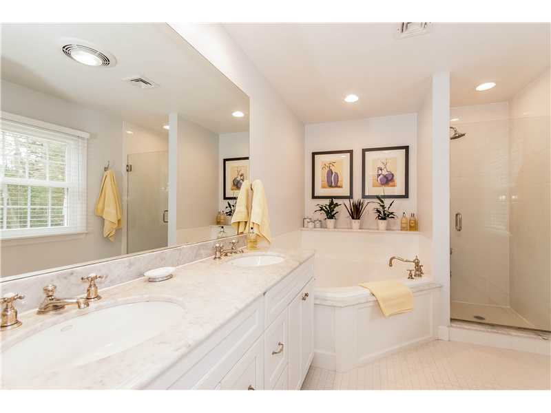 145 Marvin Ridge Road New Canaan, CT 06840 - Photo 13 of 24 a bathroom with a double vanity sink a mirror and a bathtub