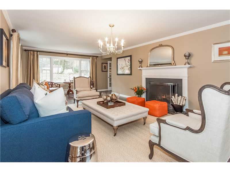 145 Marvin Ridge Road New Canaan, CT 06840 - Photo 3 of 24 a living room with furniture a fireplace and a chandelier