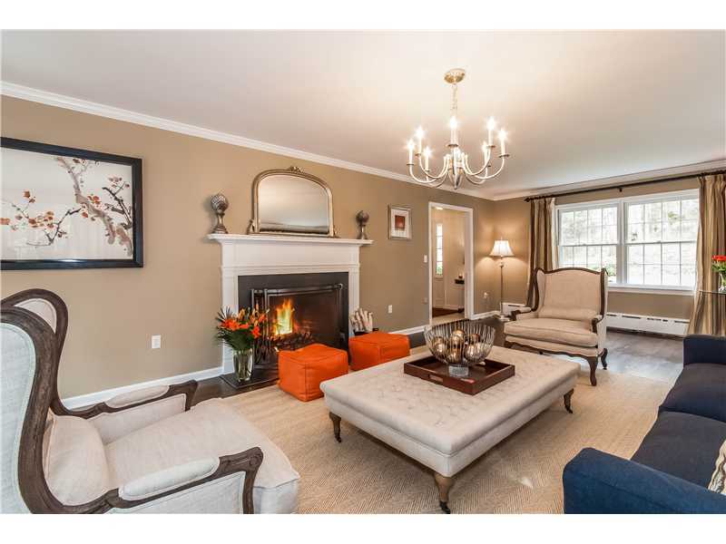 145 Marvin Ridge Road New Canaan, CT 06840 - Photo 5 of 24 a living room with furniture a fireplace and a chandelier