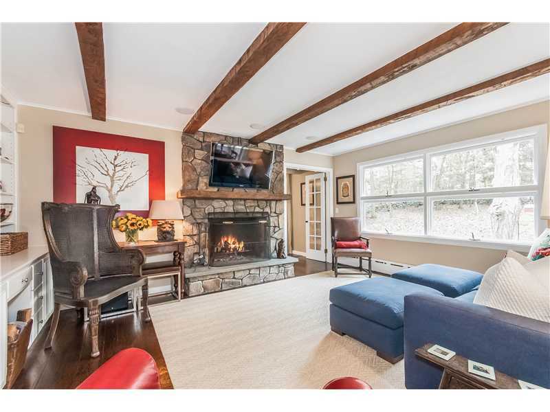 145 Marvin Ridge Road New Canaan, CT 06840 - Photo 10 of 24 a living room with furniture a flat screen tv and a fireplace