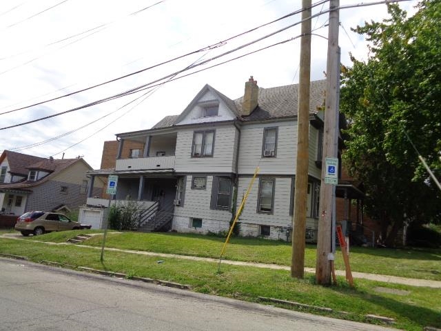 735 North Court Street Rockford, IL 61103 - Photo 5 of 14 a front view of a house with a garden and trees