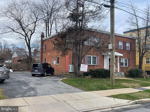 a car parked in front of a brick house