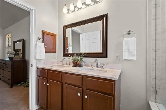 a bathroom with a double vanity sink and a mirror