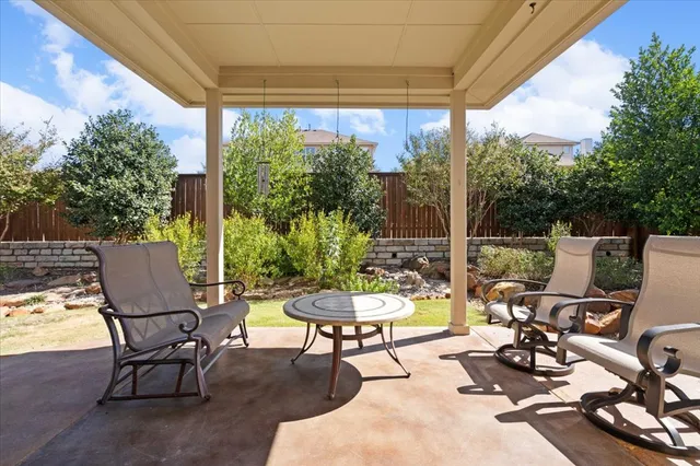 a view of a patio with a dining table and chairs