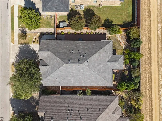 an aerial view of a house with a yard