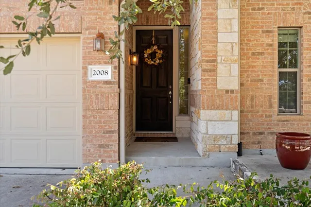 a couple of potted plants in front of door