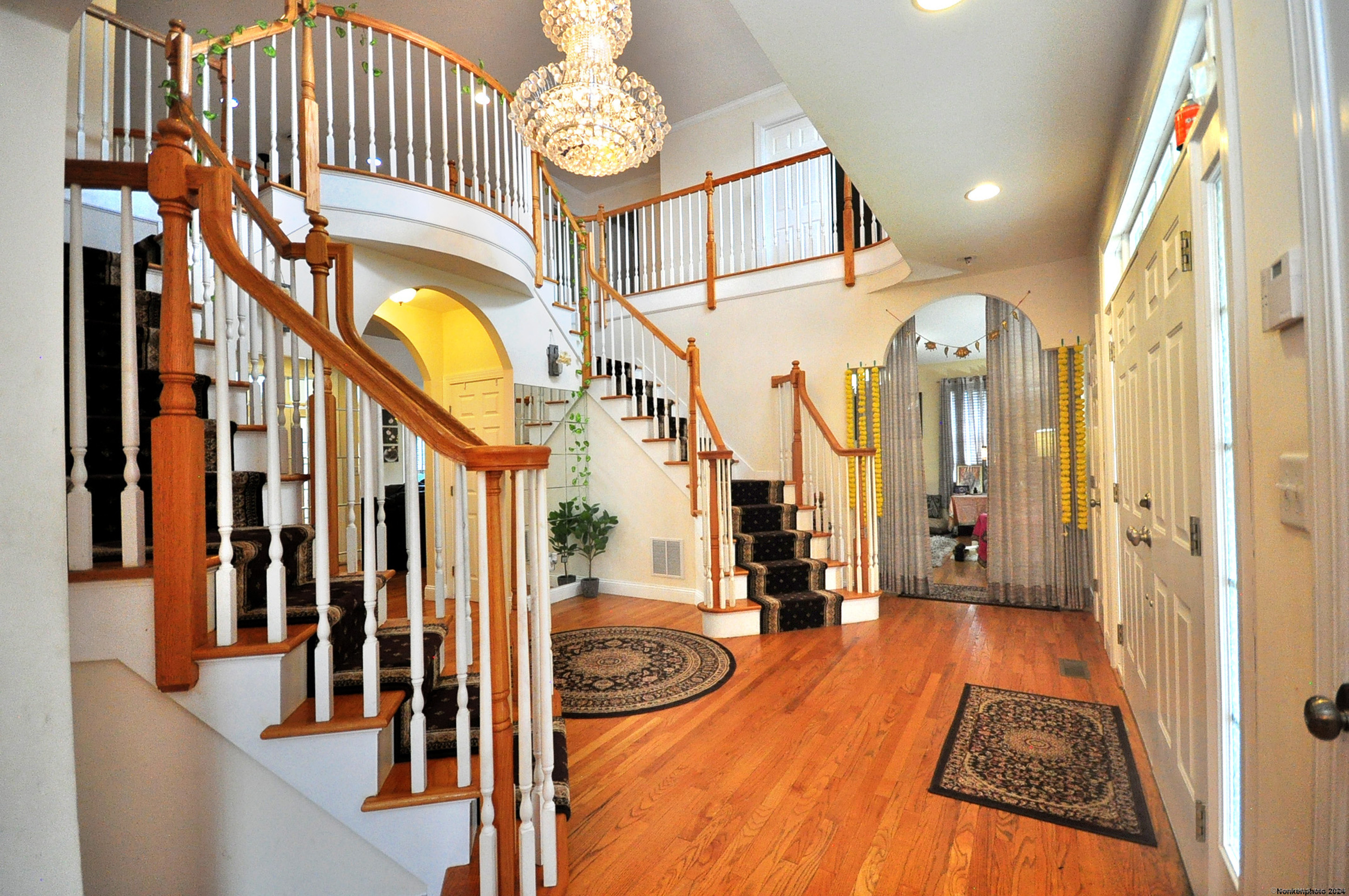 3 Maplecrest Lane Hamden, CT 06514 - Photo 15 of 40 a view of a hallway with wooden floor and a chandelier