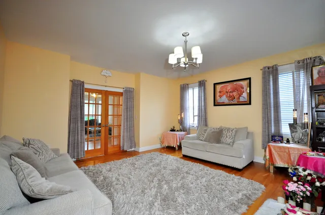 a living room with furniture chandelier and couch